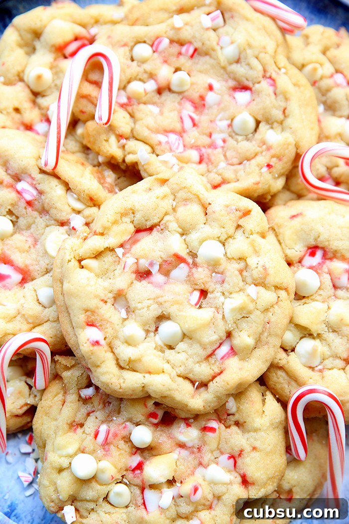 White Chocolate Peppermint Cookies with small candy canes on a large plate.