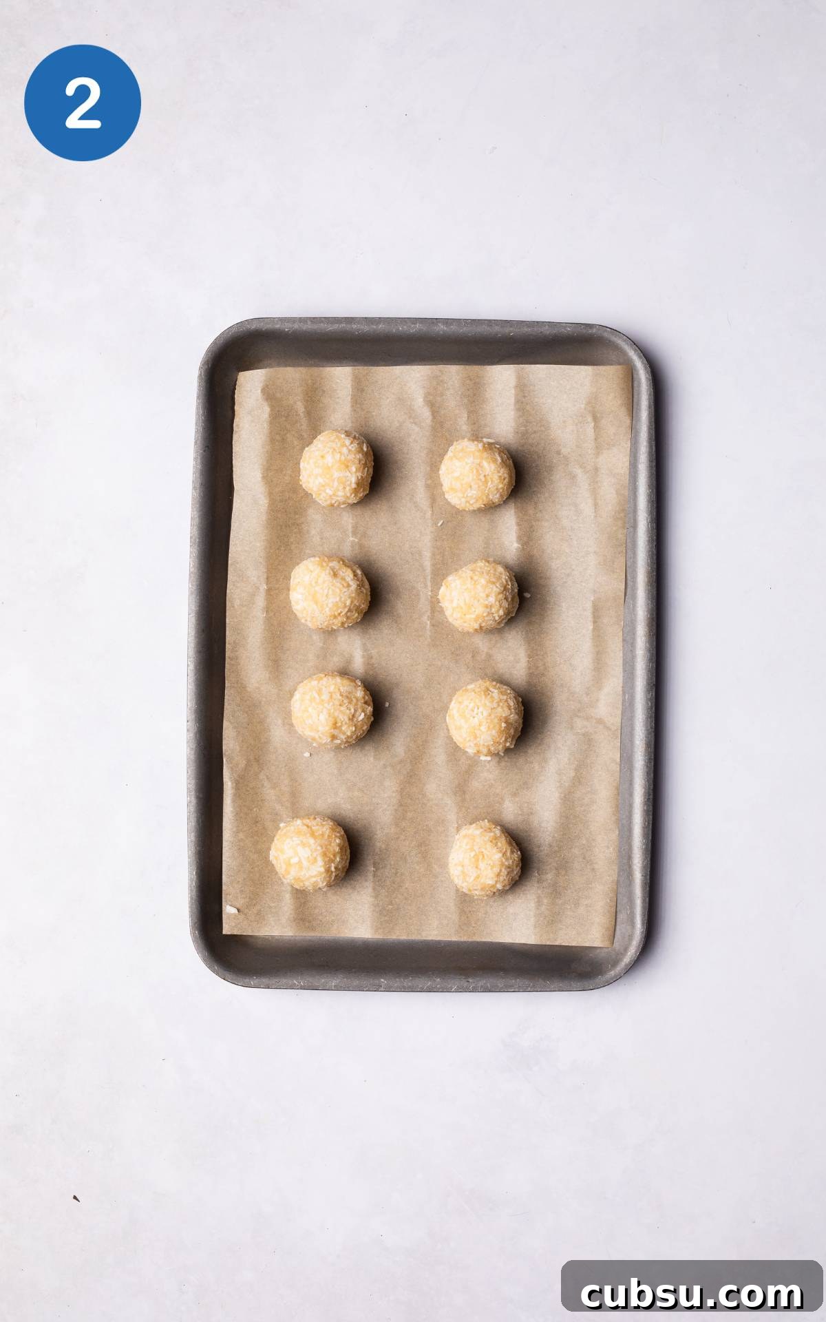 No-Bake Chocolate Coconut Energy Bites 5 Chocolate Coconut Balls on a baking tray.