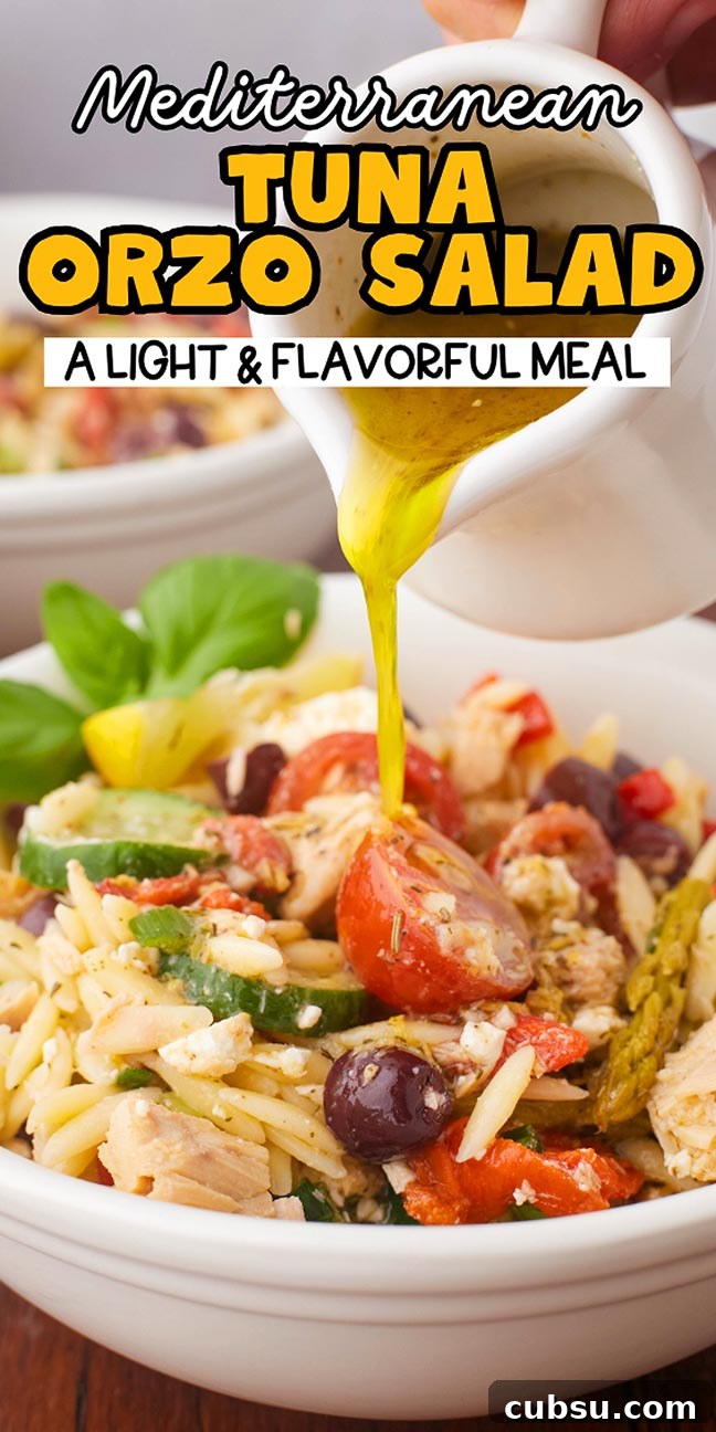 Mediterranean Tuna Orzo Salad with Olives, Feta & Lemon 20 A bowl of Mediterranean tuna orzo salad sprinkled with olives, tomatoes, and fresh vegetables is beautifully drizzled with dressing.