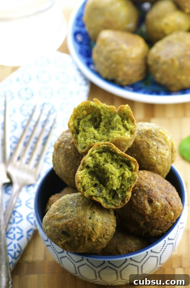 Close up view of a plate filled with Spinach and cheese donut holes