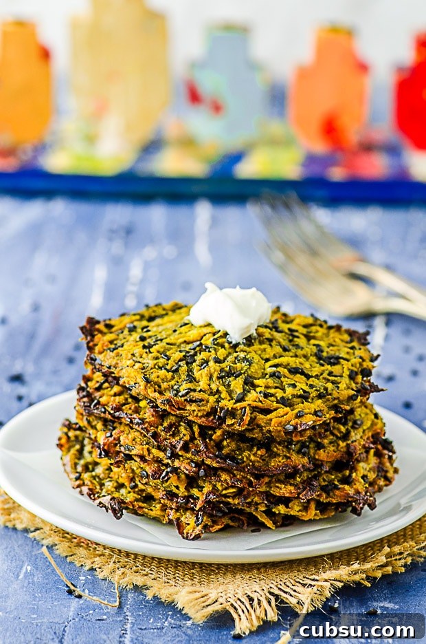 Butternut squash Latkes staked on a white plate with a Menorah in the background