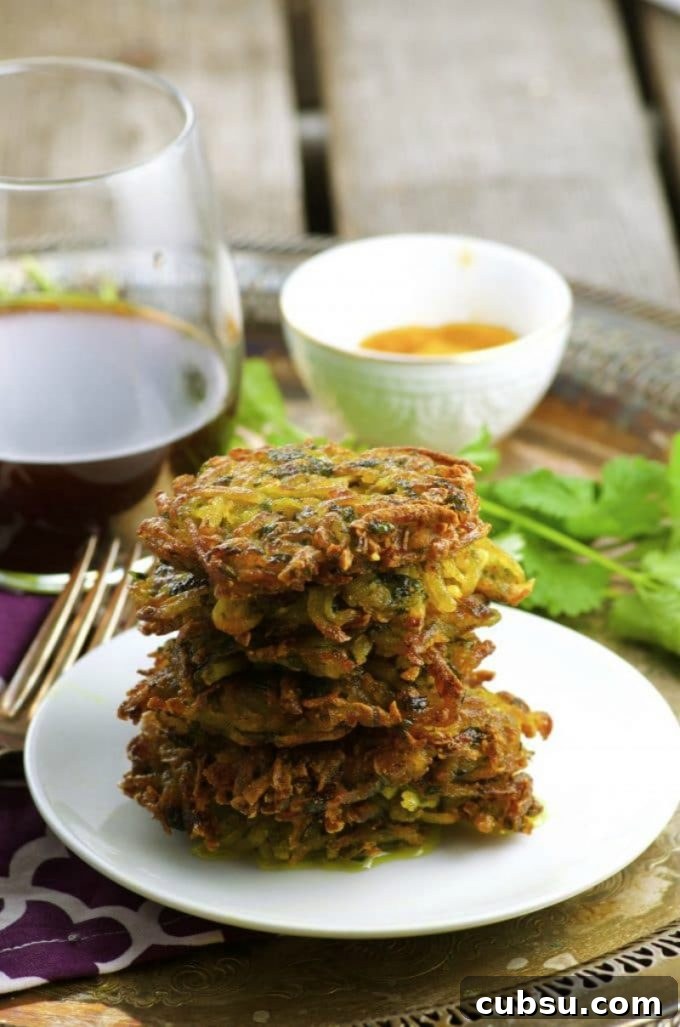 A small white plate with 6 vegan potato latkes stacked