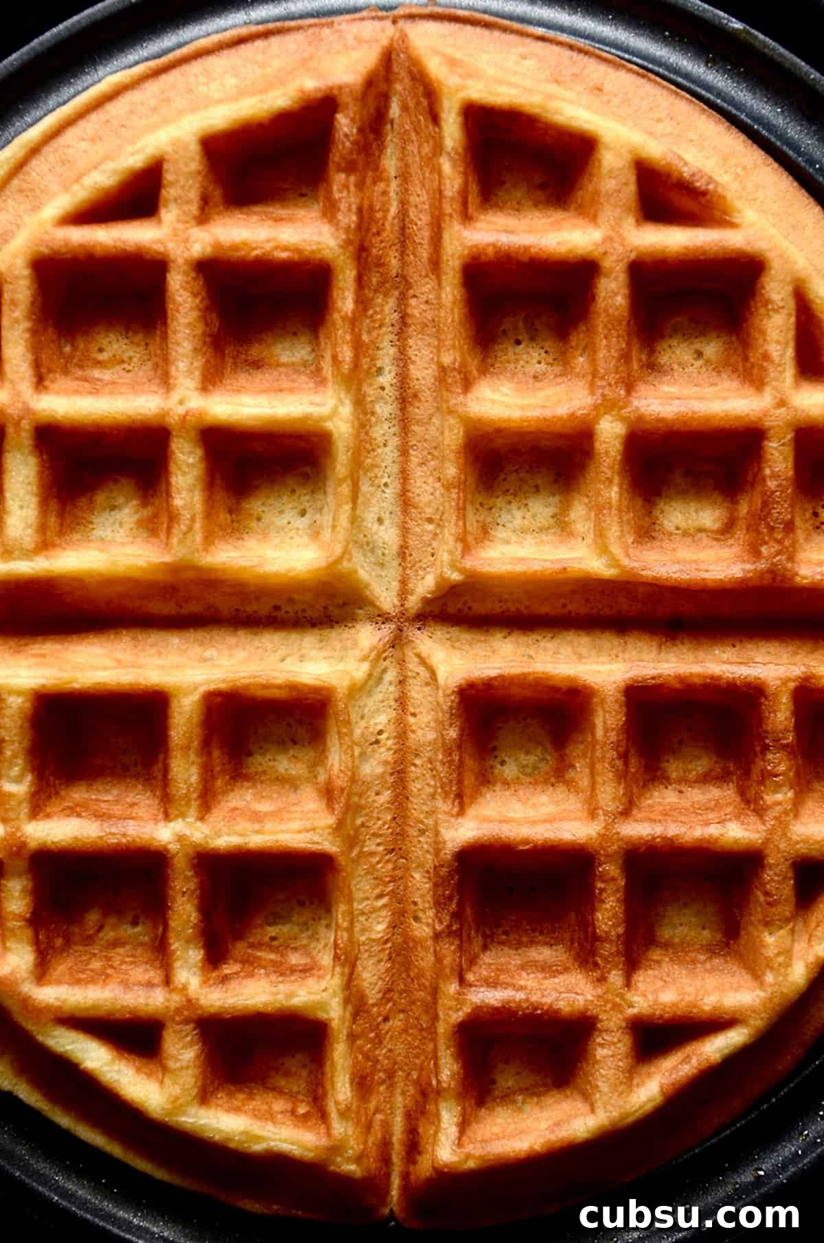 Crispy Belgian Waffles Recipe for Brunch and Weekend Mornings 11 Crispy, golden Belgian waffle in a waffle iron.