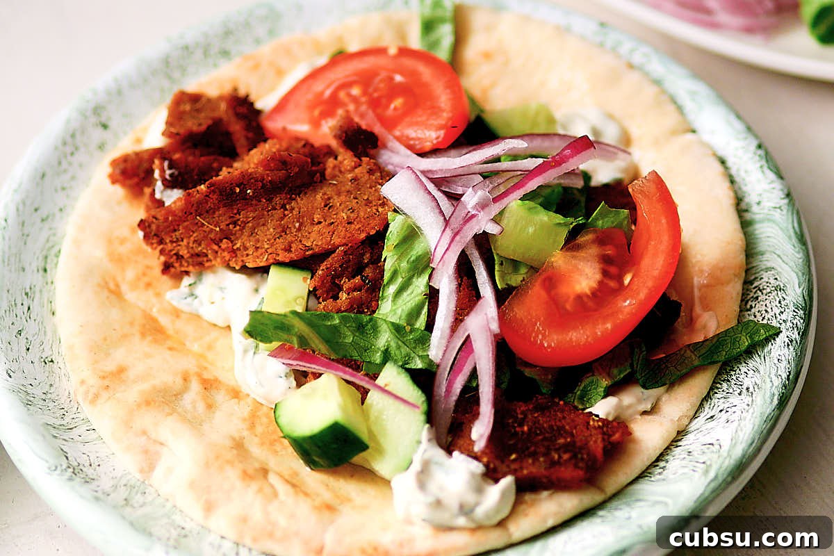 Seitan Vegan Gyros: Flavorful Plant-Based Greek Wrap Recipe 11 Assembling a vegan gyros with seitan, pita, tzatziki, and veggies.