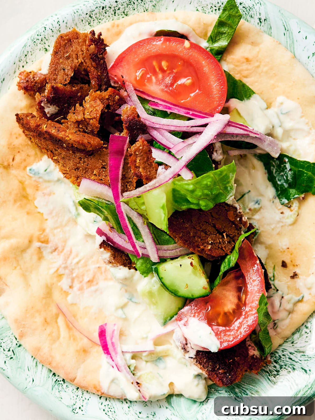 Seitan Vegan Gyros: Flavorful Plant-Based Greek Wrap Recipe 15 Vegan gyros with seitan, tzatziki, pita, tomatoes, red onion, and cucumber.