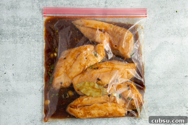 Grilled Filipino Adobo Chicken Recipe for Smoky, Tangy Flavor 7 Chicken breasts in a Ziploc bag with adobo marinade.