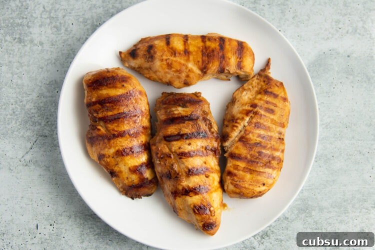 Grilled Filipino Adobo Chicken Recipe for Smoky, Tangy Flavor 8 Grilled adobo chicken on a large round white plate.