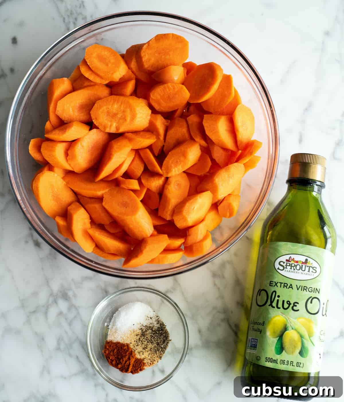 overhead view of the sliced carrots and spice mixture for this roasted carrots recipe