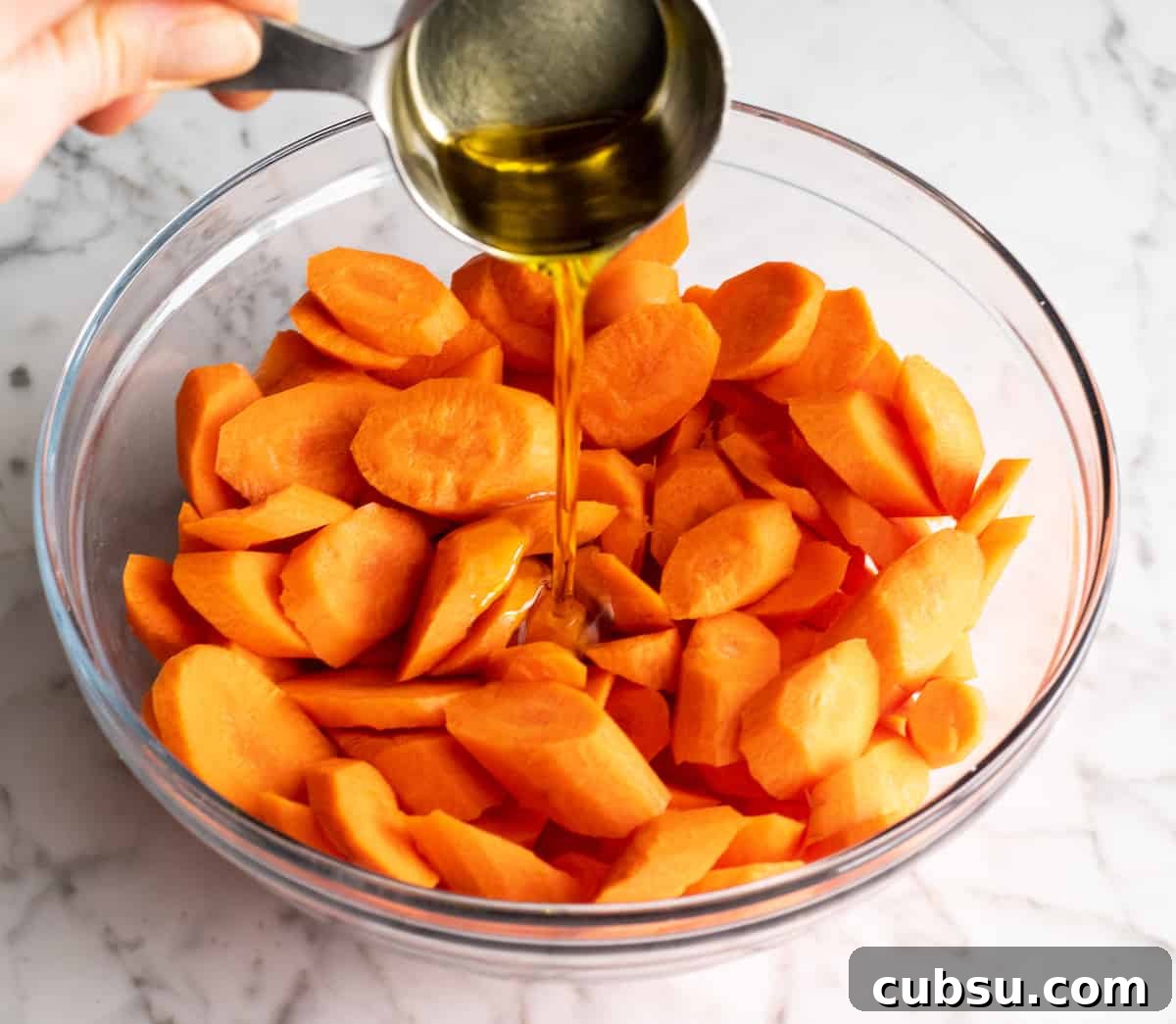 photo showing how to roast carrots - coating with olive oil