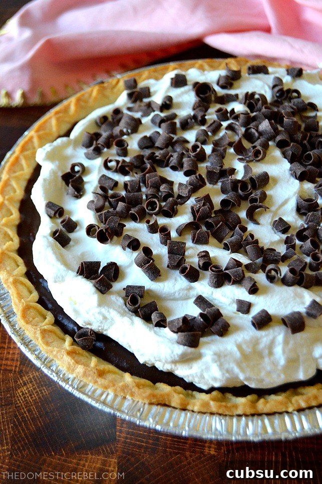 Chocolate cream pie in a pie pan with a pink towel