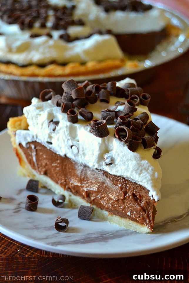 Closeup slice of chocolate cream pie on a white plate