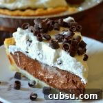 slice of chocolate cream pie on a white marble plate