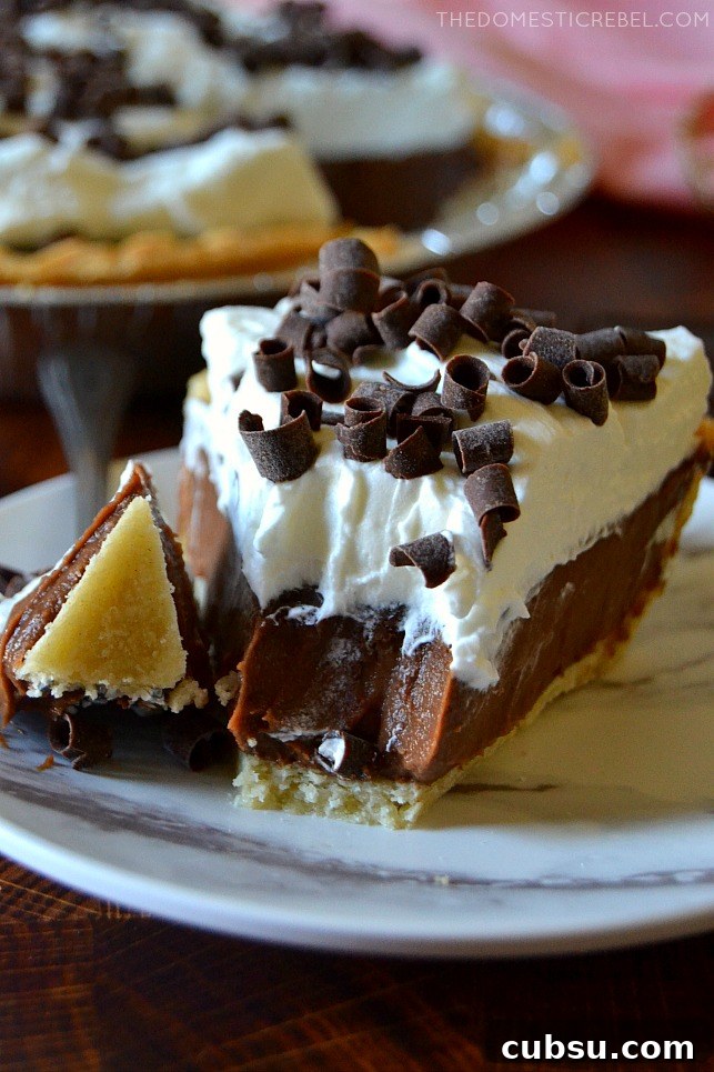 Closeup slice of chocolate cream pie with a bite missing