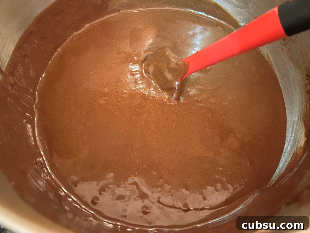 Decadent Mocha Cupcakes: Rich Coffee Chocolate Recipe 3 Thin chocolate cake batter in mixing bowl.