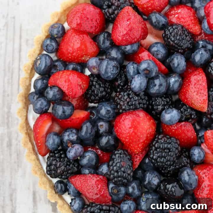 A skyr tart with fresh berries on a wooden surface