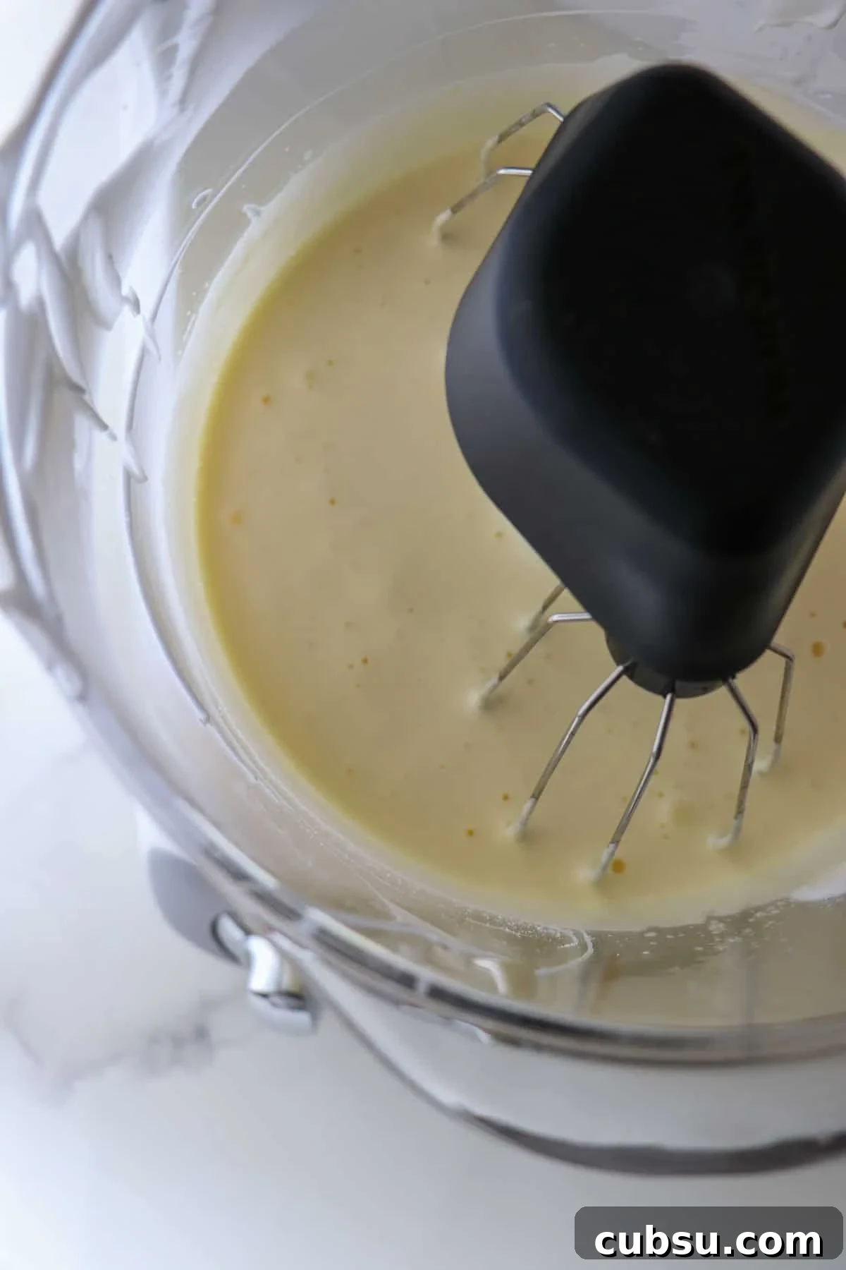 Egg yolks mixed together in a stand mixer.