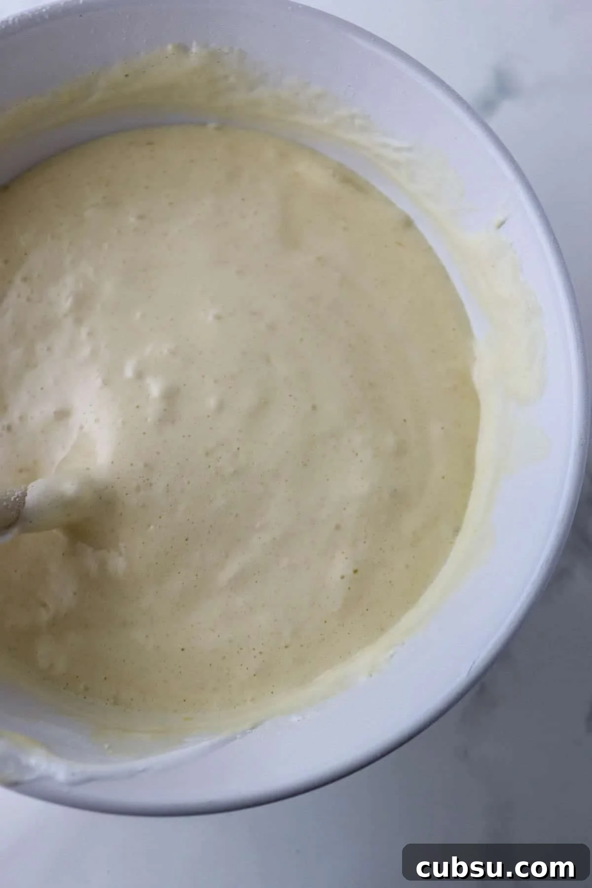 Traditional Swedish Rulltårta cake batter in a bowl.