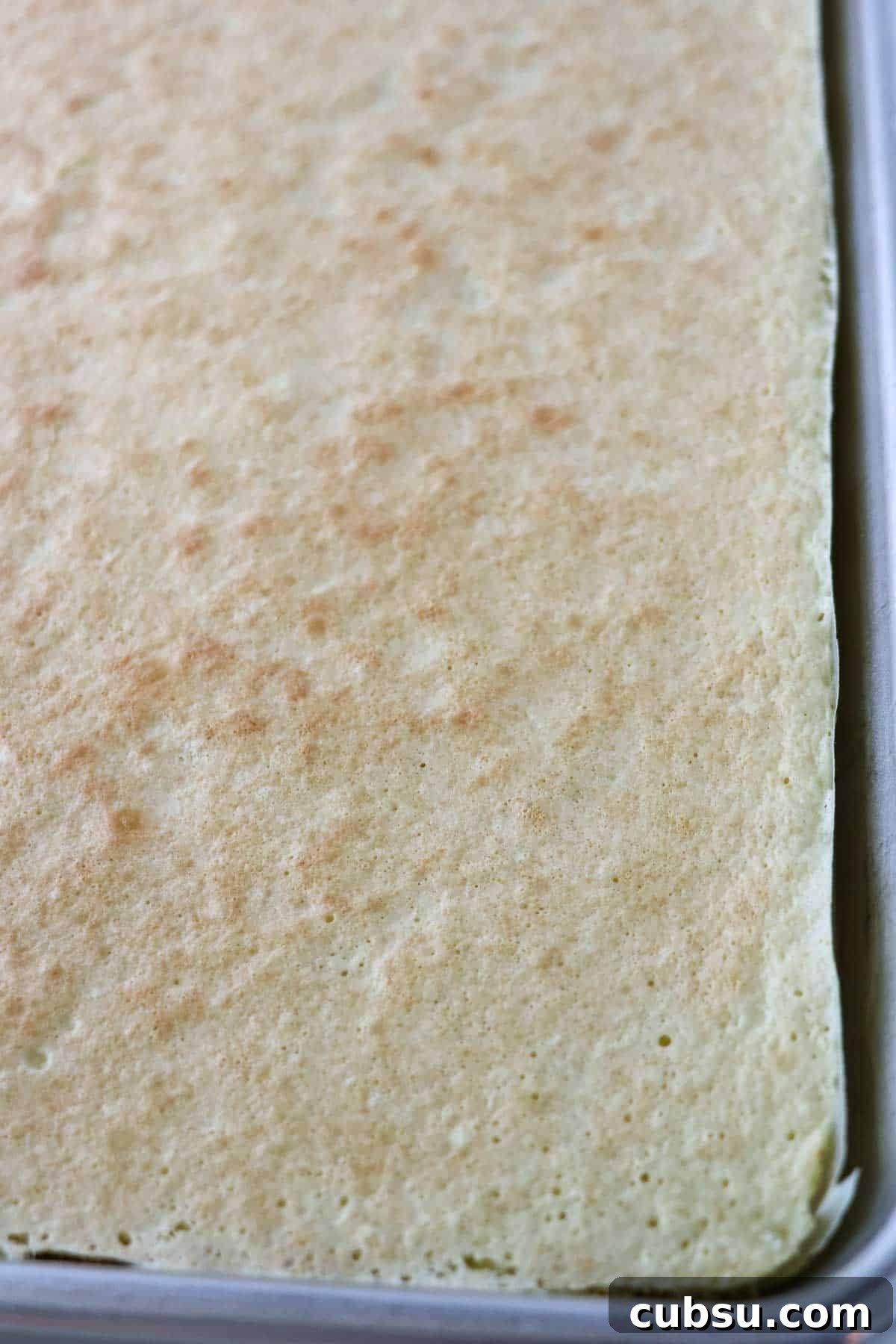 Baked Swedish Rulltårta in a pan.