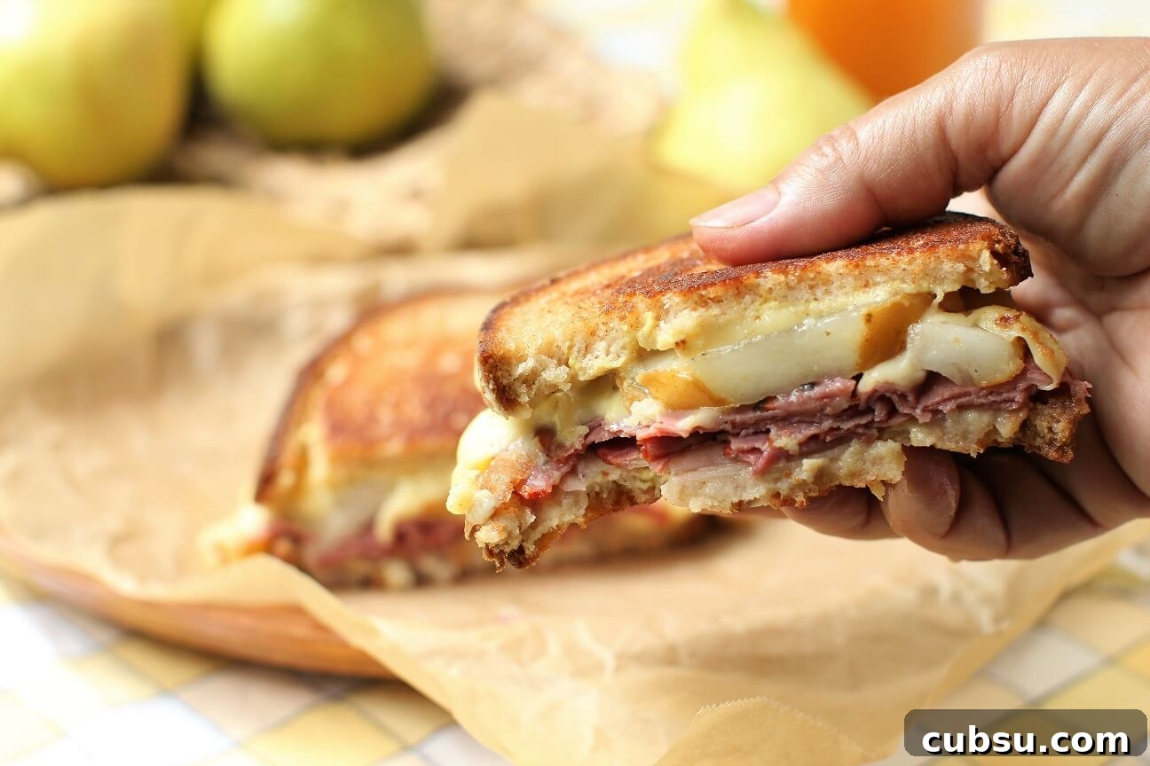 Pastrami and Pear Grilled Cheese Sandwich Recipe 12 a bite taken out of the amazing Pear & Pastrami Grilled Cheese Sandwich