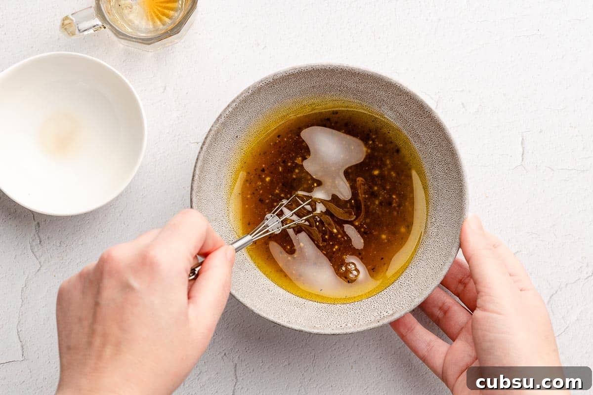 dressing being whisked in small bowl with small dish on the side