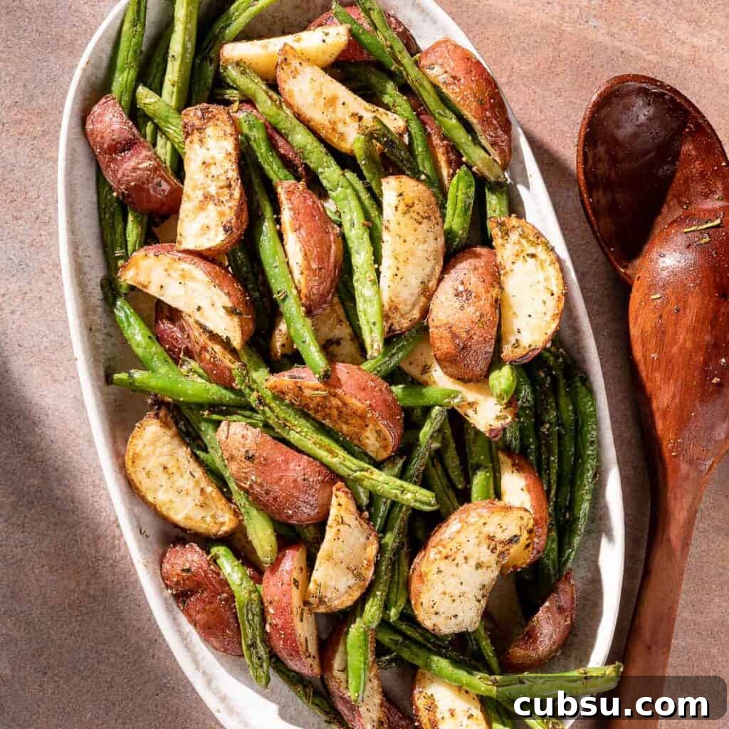 potatoes and green beans on platter with serving spoon on the side