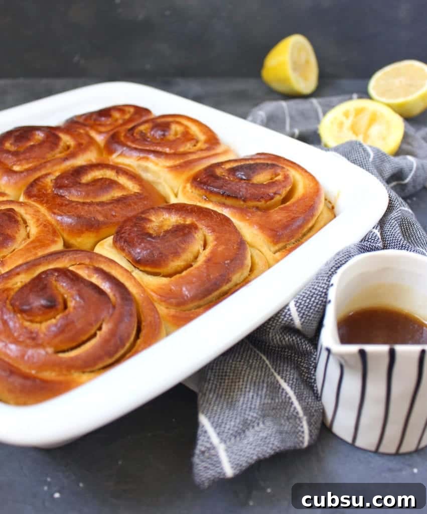 Lemon Glazed Sweet Rolls Recipe – Soft, Zesty Breakfast Buns 3 Baked buns in a white ceramic dish.