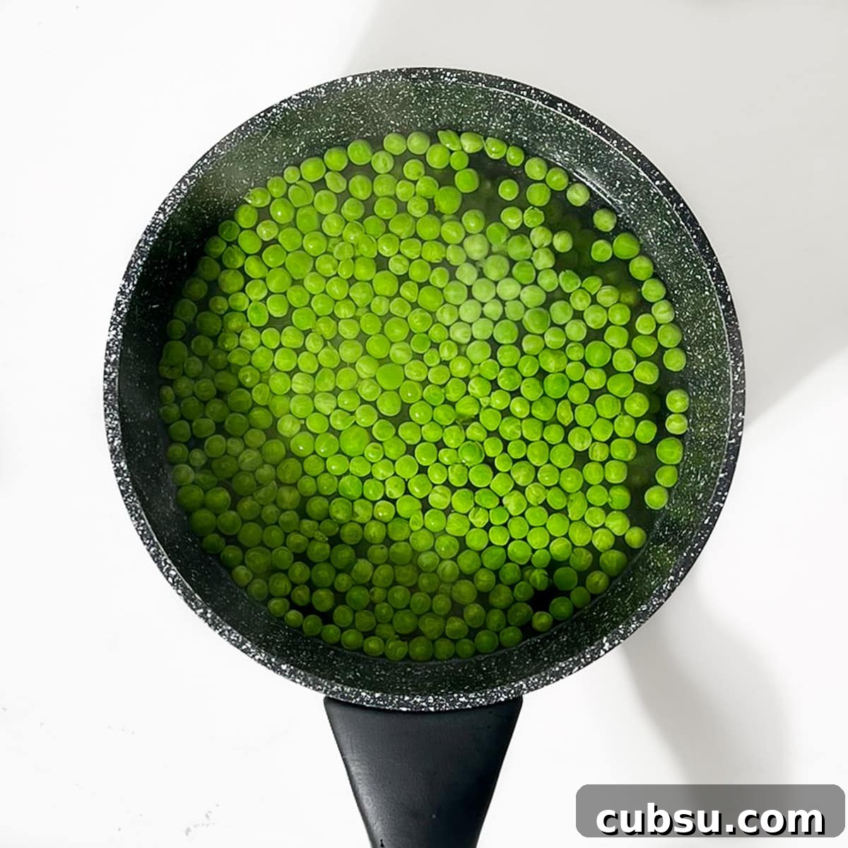 Crispy Cheesy Green Pea Fritters Recipe 4 Boiling the petit pois in a small saucepan.
