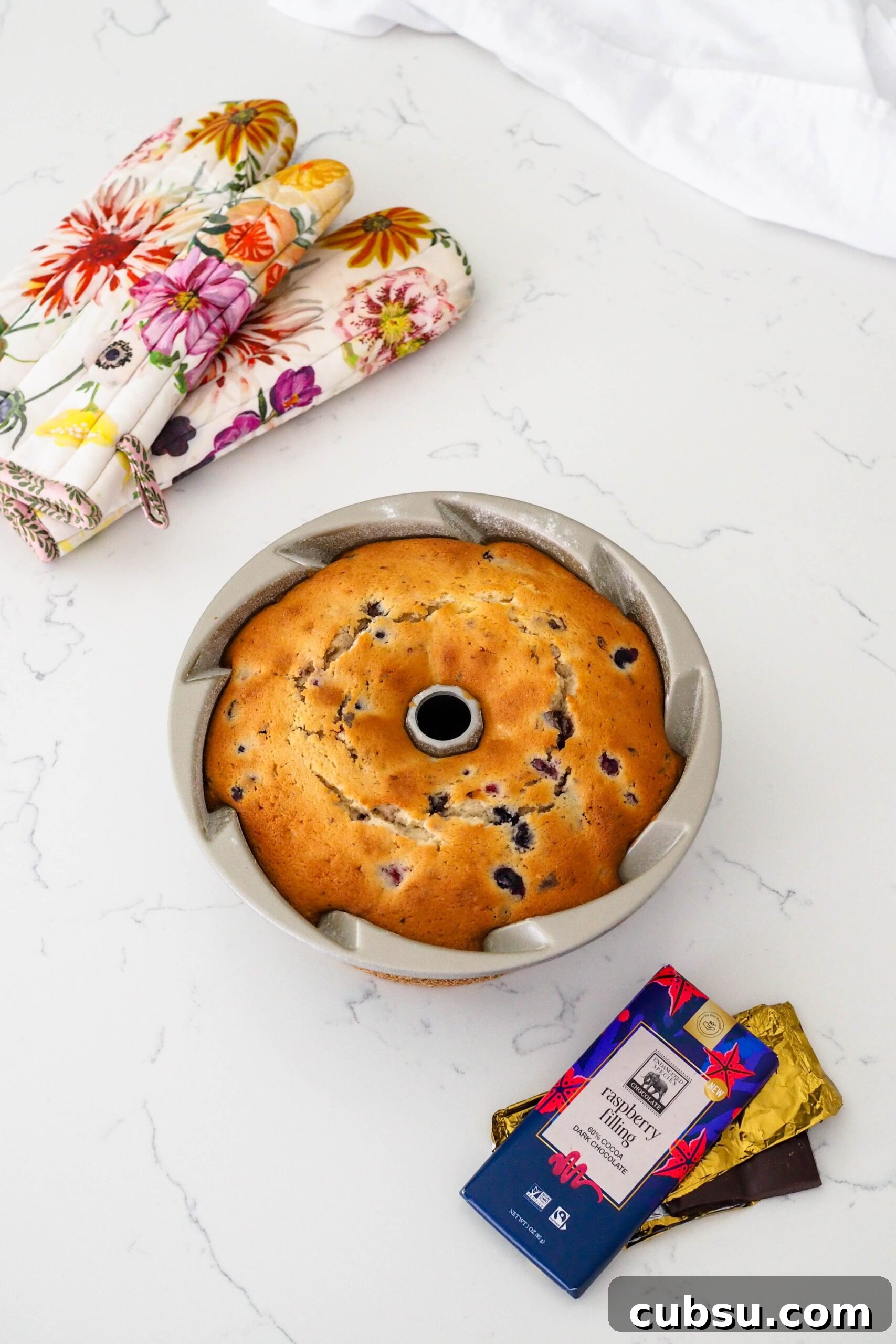 A baked berry Bundt cake cools in the pan.