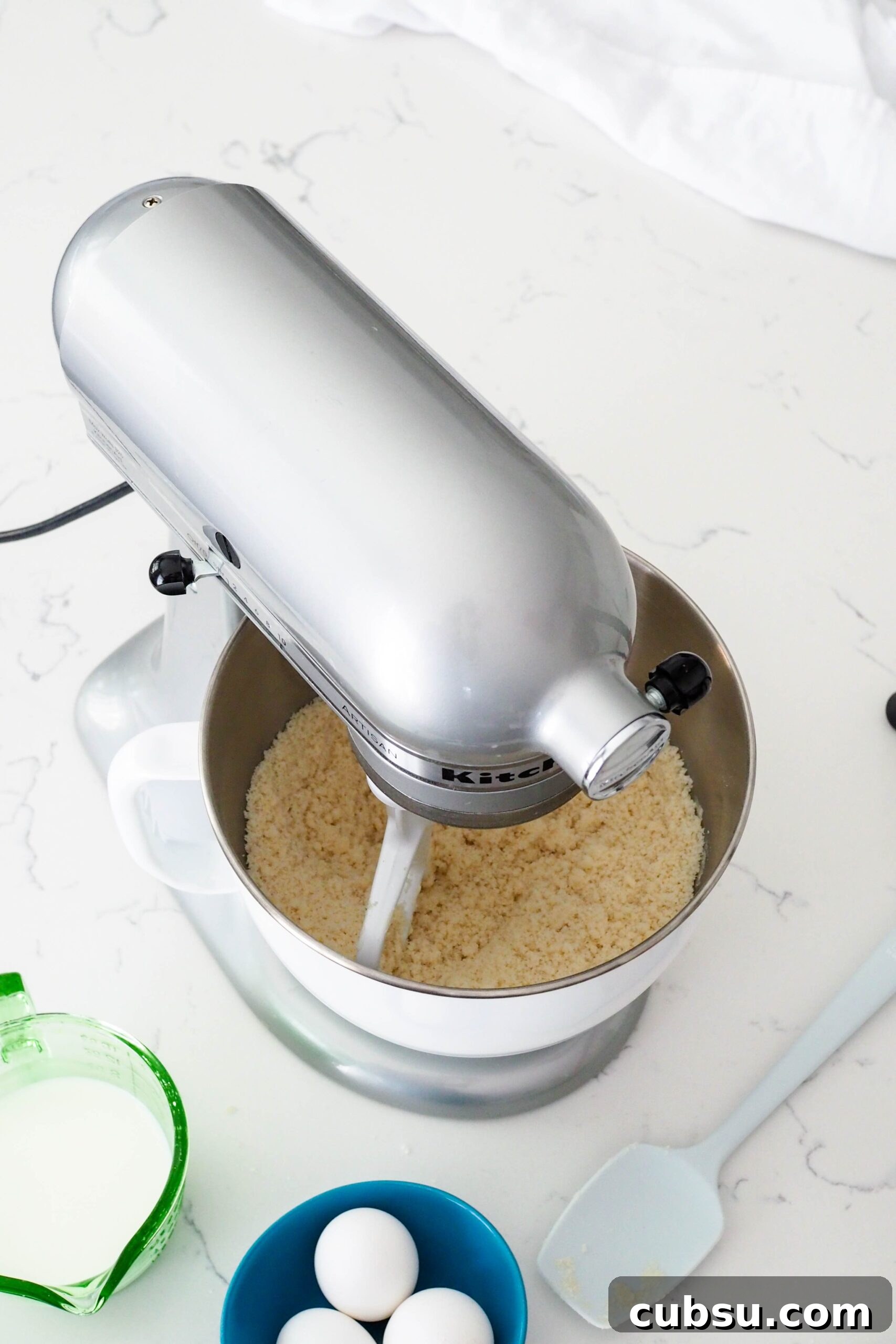Dry ingredients mixed together with butter in a stand mixer.