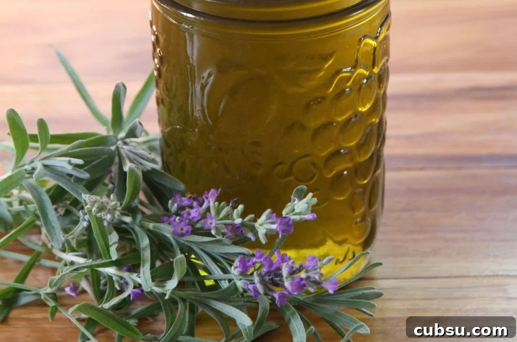 Fresh lavender adorning the base of a jar of lavender infused oil. 