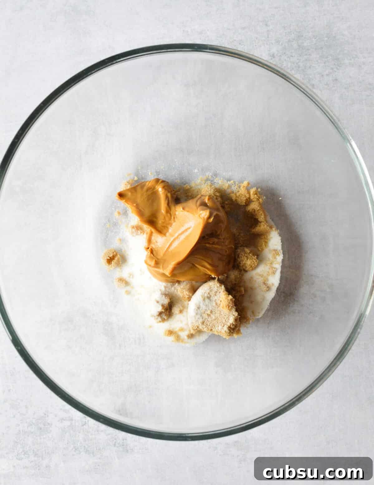 Flourless Peanut Butter Cookies Recipe — Chewy & Gluten-Free 4 peanut butter, sugar, and brown sugar in a bowl.