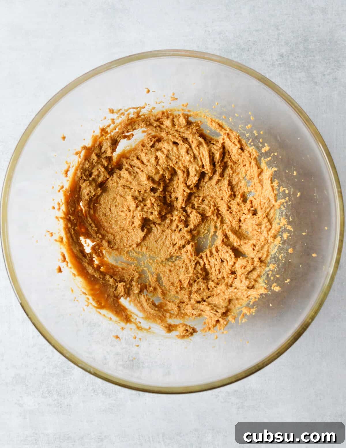 Flourless Peanut Butter Cookies Recipe — Chewy & Gluten-Free 5 whipped peanut butter and sugar in a bowl.