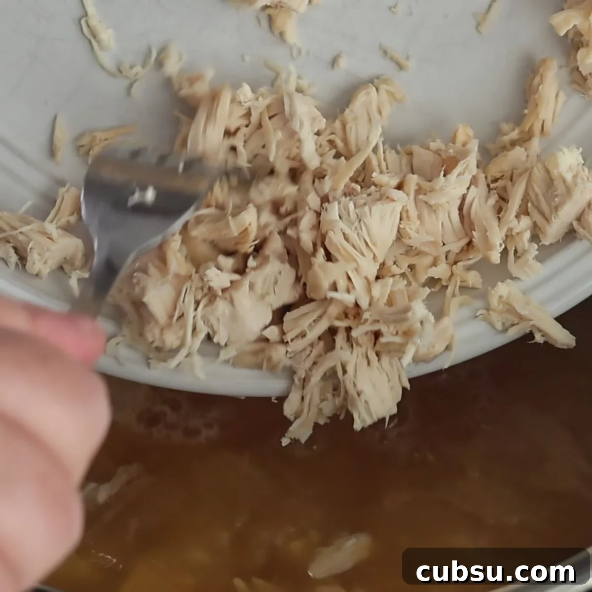adding shredded chicken to soup in instant pot.