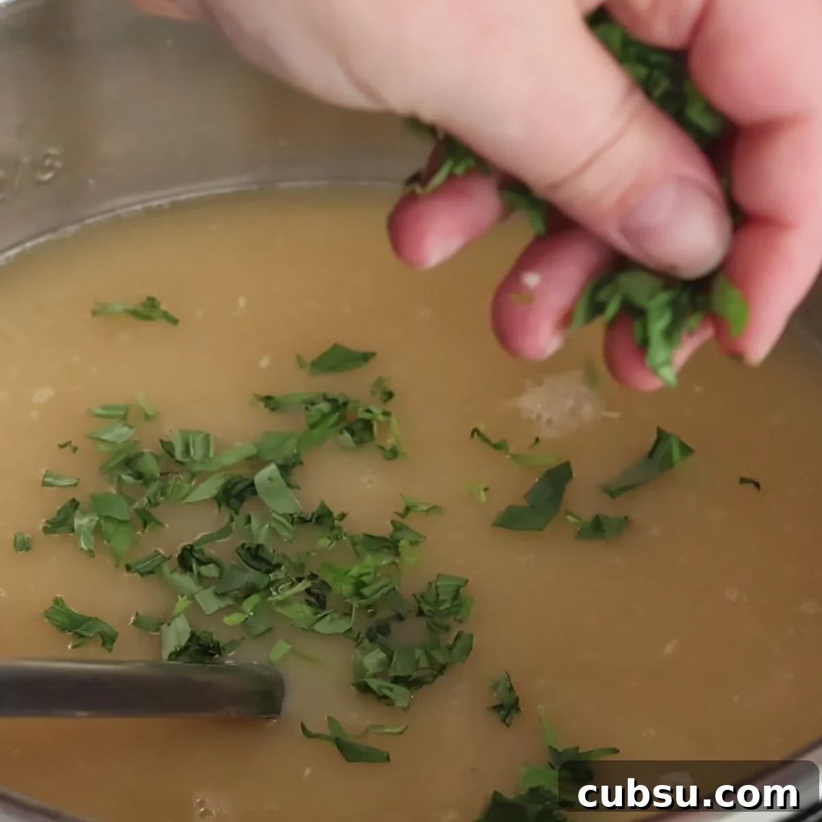 sprinkling chopped tarragon on top of soup.