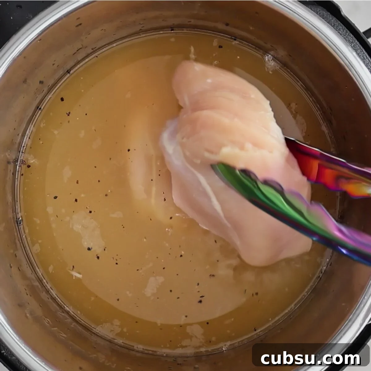 adding raw chicken breasts to soup in instant pot.