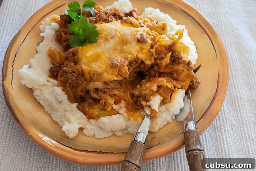 a serving of cheesy cabbage chorizo casserole on a plate