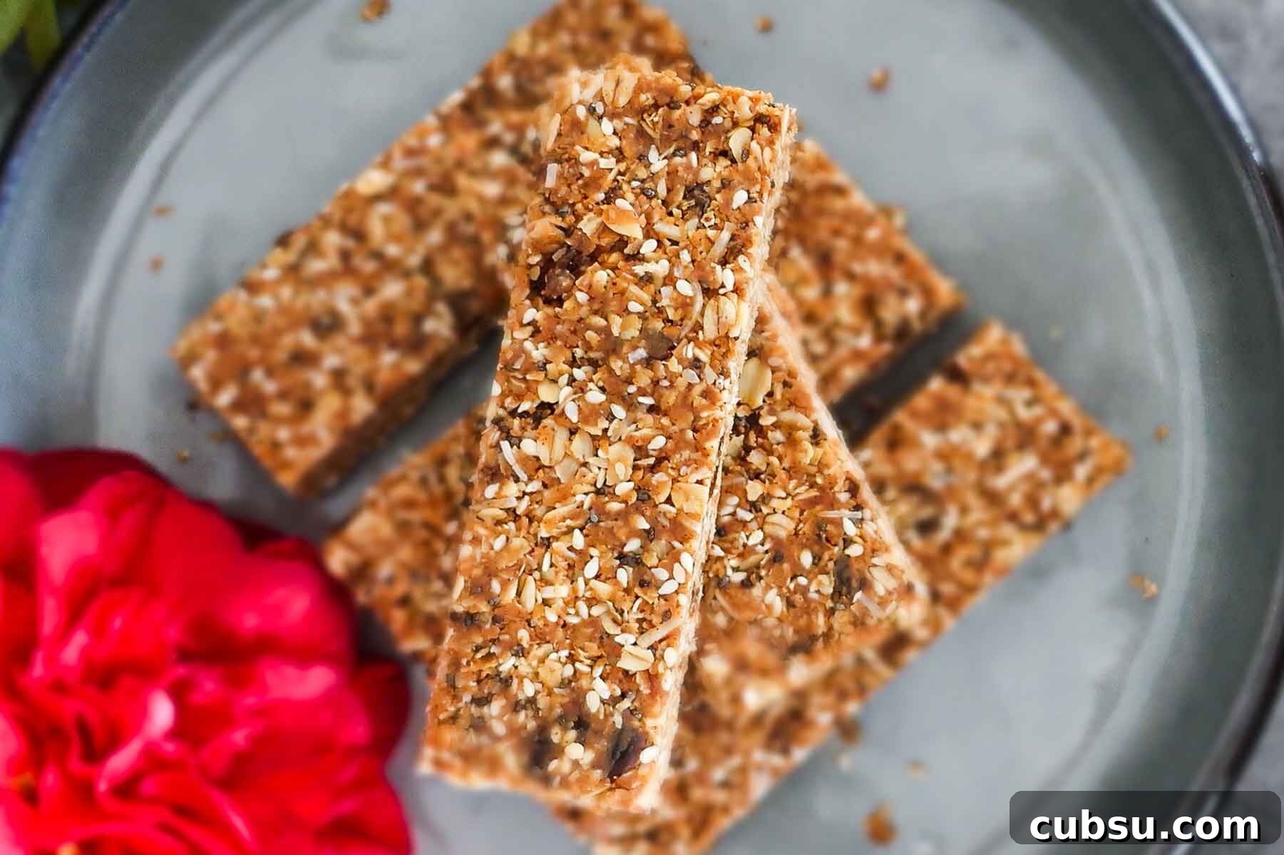 gluten free granola bars stacked on a plate with a rose