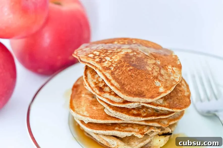 stacked apple cinnamon buckwheat pancakes on a plate