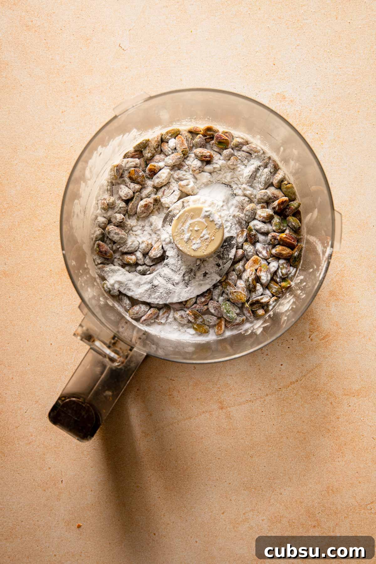 A food processor with pistachio and potato starch.