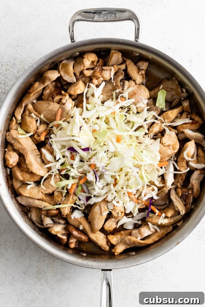 Adding slaw mix to browned chicken.