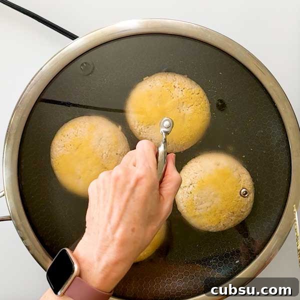 Placing a lid on the skillet to trap in steam.