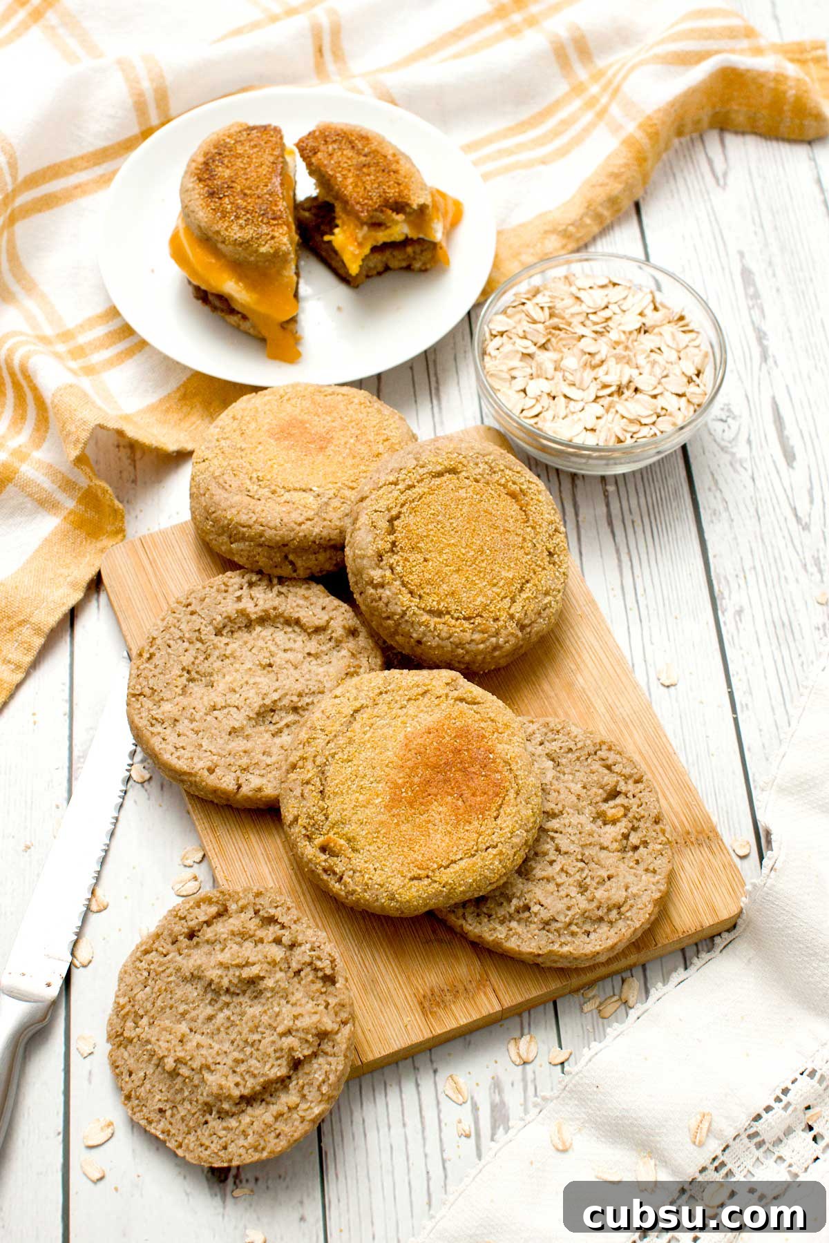 Oat flour English muffins on a cutting board.