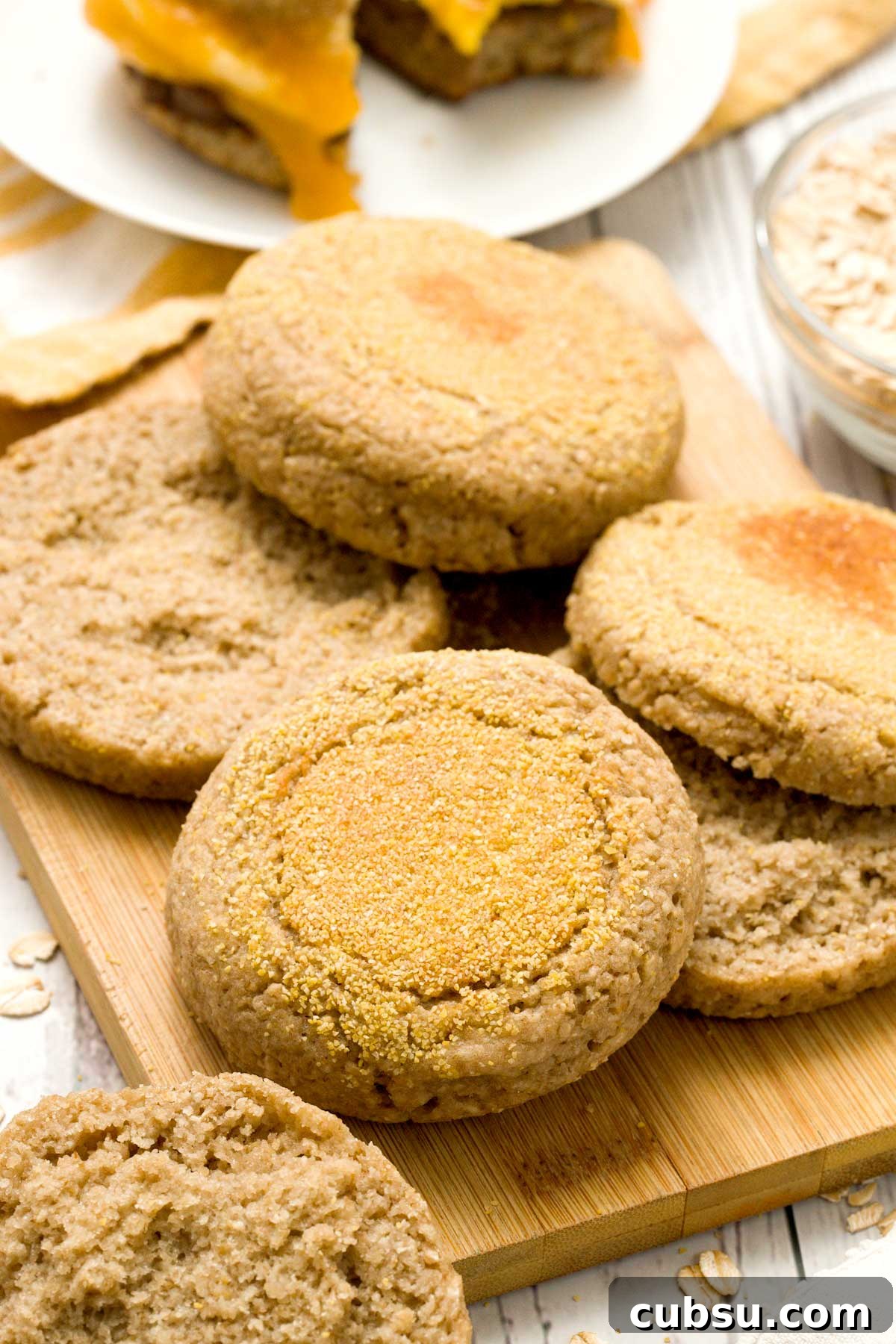 Oat flour English muffins on a cutting board.