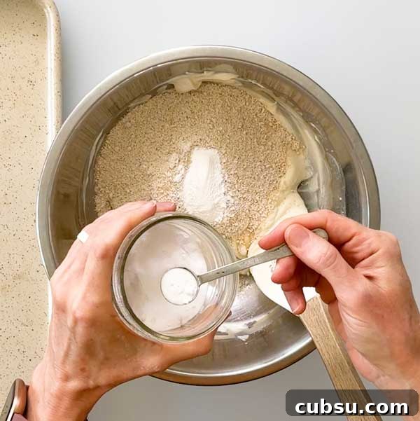 Adding the dry ingredients to the muffin dough.