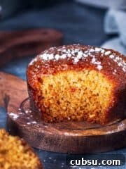 A square photo of pudding cake cut to show its interior texture.