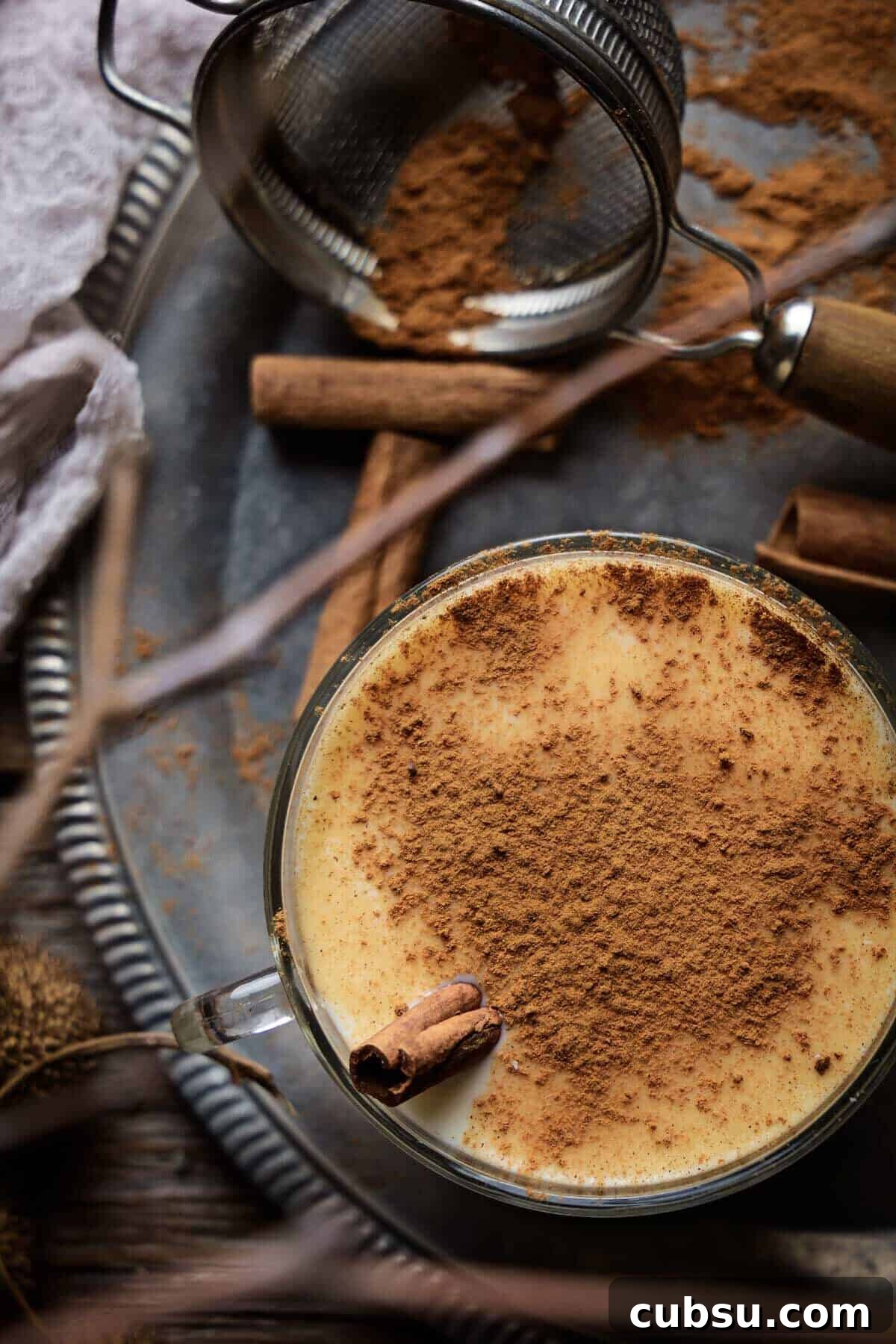 Melktertjies Milk Tart Cocktail Recipe: Creamy South African Drink 10 An overhead shot of the milk tart cocktail sprinkled with cinnamon.
