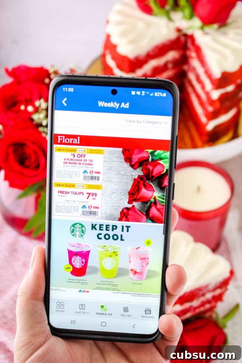 hand holding a smartphone showing floral coupons in Albertsons app