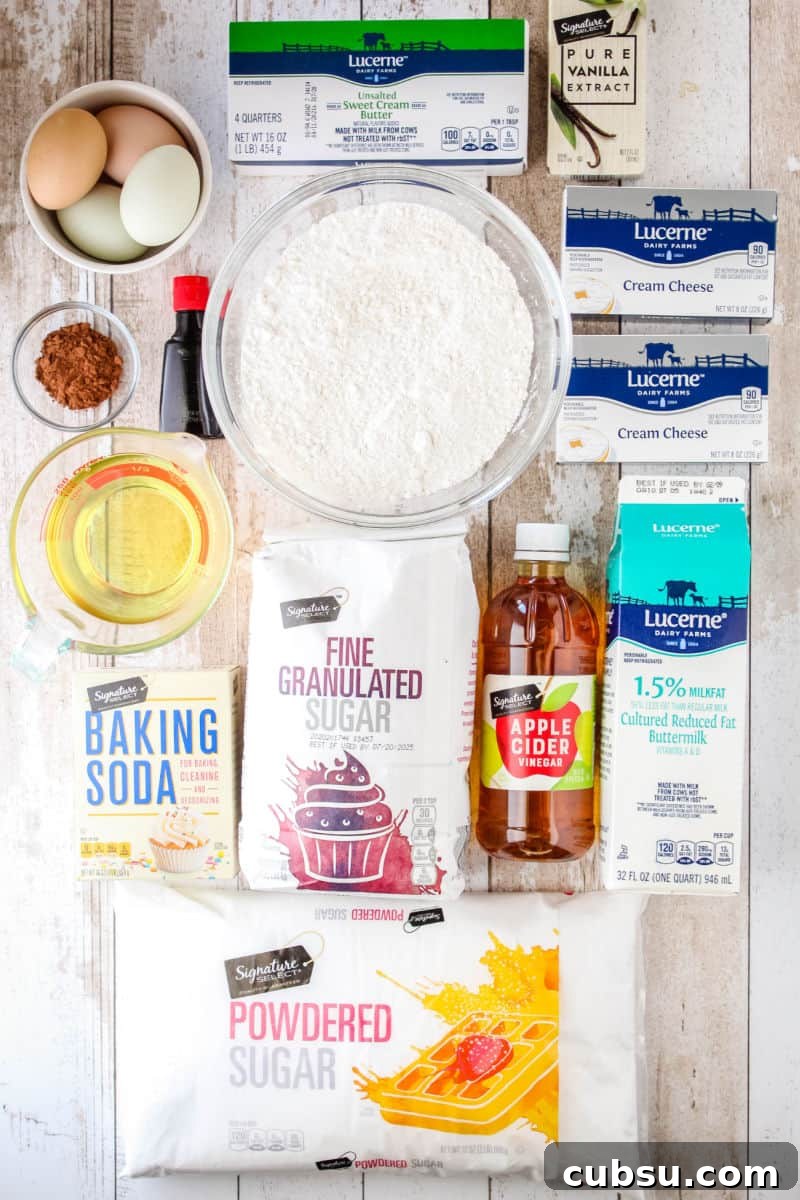 ingredients to make red velvet cake and cream chees frosting laid out on a tabletop