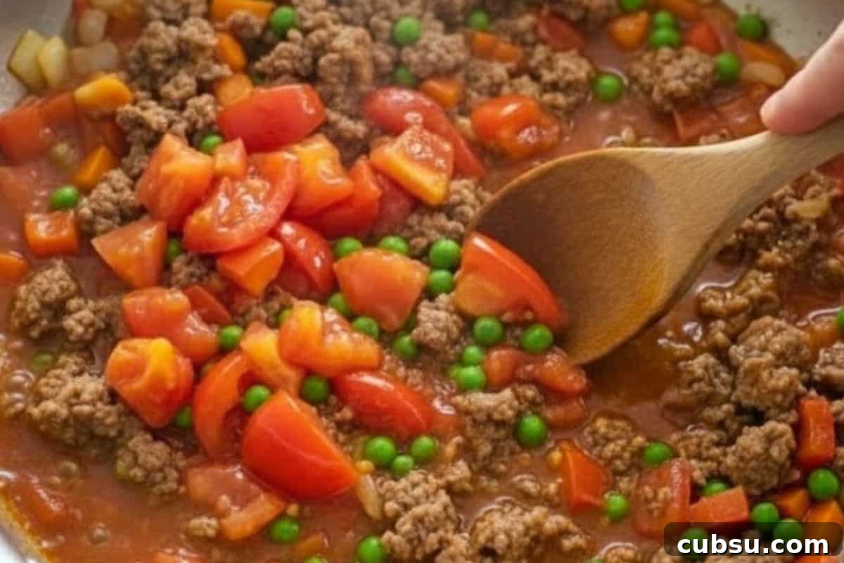 Add tomatoes and cover pan while they soften. Stir in peas, salt, and vegetable stock and simmer until all vegetables are tender.