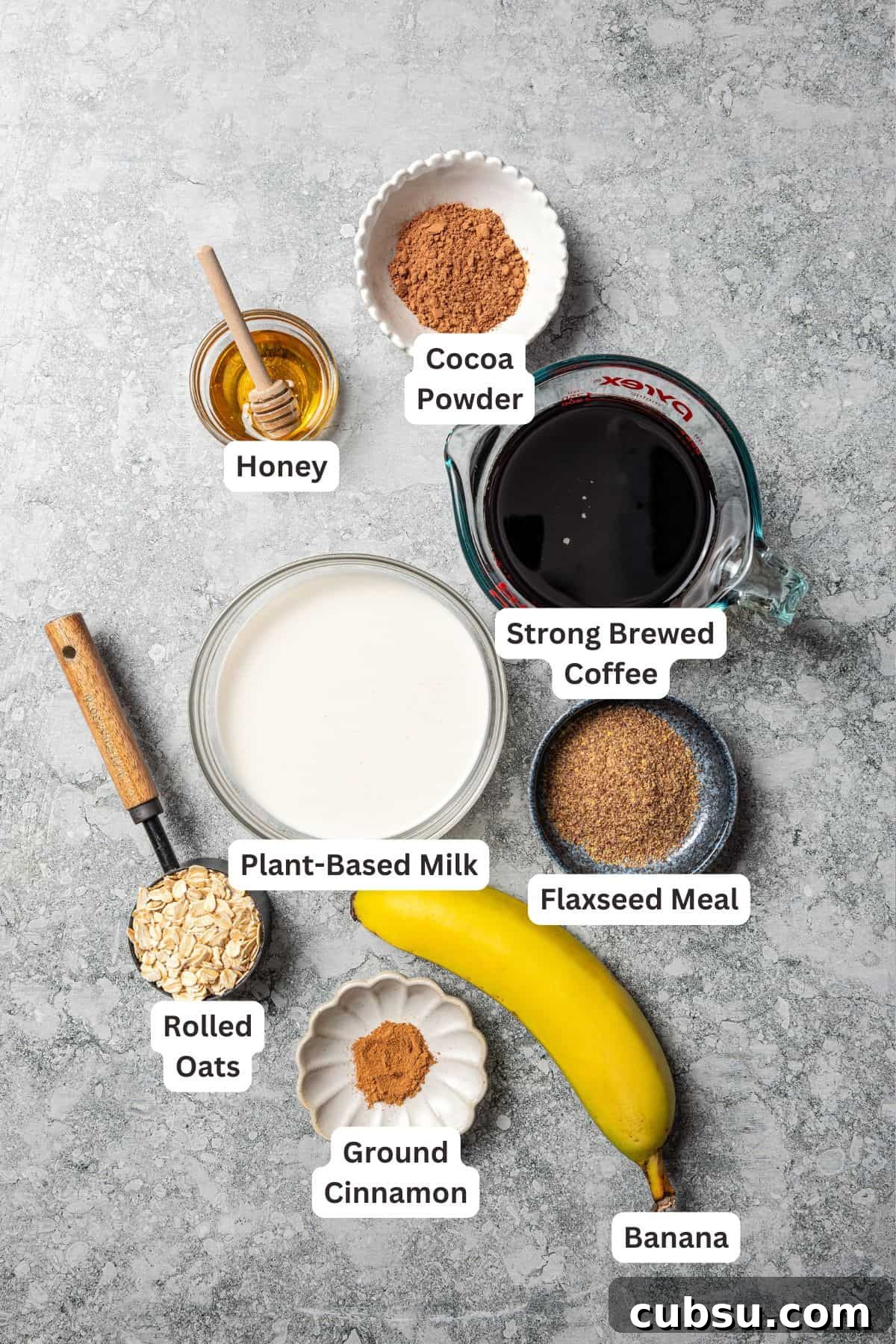 This creamy coffee smoothie is a delicious and satisfying way to start busy mornings! It’s packed with oats, flaxseed, and bananas for a flavorful, filling treat. Coffee smoothie ingredients with text labels overlaying each ingredient.
